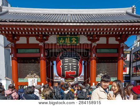 Crowd Of Tourists By Giant Red Lantern In Kaminarimon Gate Of Senso-ji Temple In Asakusa Area. It Is