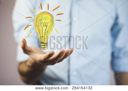 Man Hand Light Bulbin  Screen On Table