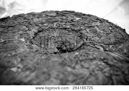 Chinese Pressed Puer Tea On Wrapping Paper, Close-up, Macro