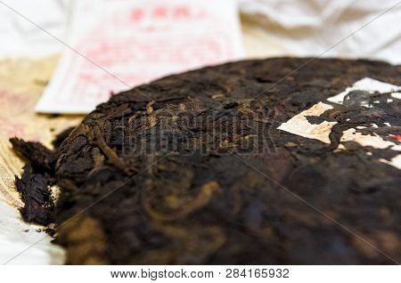 Chinese Pressed Puer Tea On Wrapping Paper, Close-up, Macro
