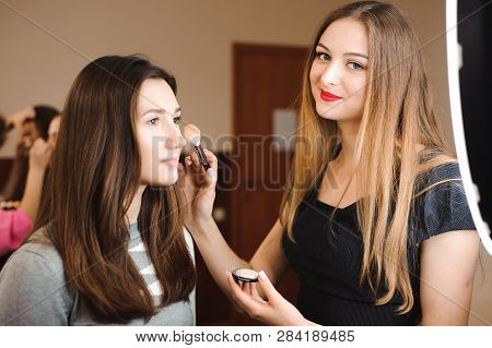 Make Up Artist Doing Professional Make Up Of Young Woman.