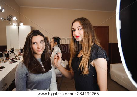 Make Up Artist Doing Professional Make Up Of Young Woman.