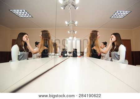 Make-up Artist Doing Professional Make-up Of Young Woman.