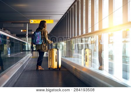 The Girl Is Riding On The Travolator