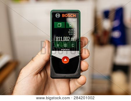 Paris, France - Jan 19, 2018: Worker Hand Holding Accurate Laser Meter Manufactured By Bosch Model P