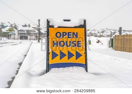 Open House Sign Against Snow Covered Landscape
