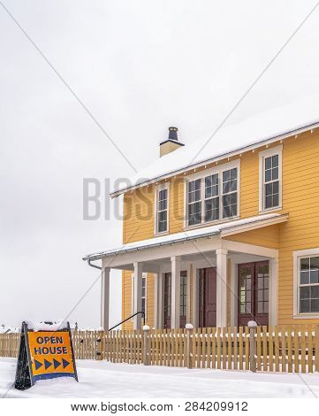 Open House Sign And Home Against Snow And Sky