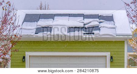 Solar Panels On Snow Covered Roof In Winter