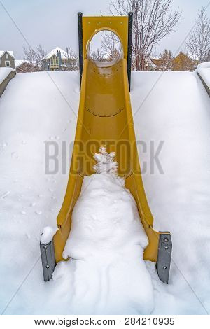 Vibrant Slide Against Powdery Snow In Winter