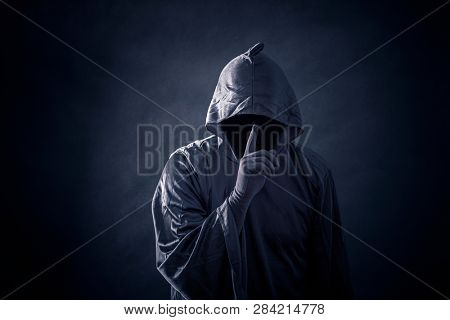 Scary figure in hooded cloak 