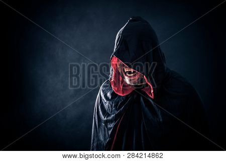 Angry vampire with red cape showing his scary teeth