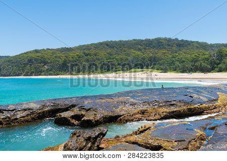 People Enjoying The Sunny Weather At Pebbly Beach, A Popular Camping Area With Great Surfing Beach A