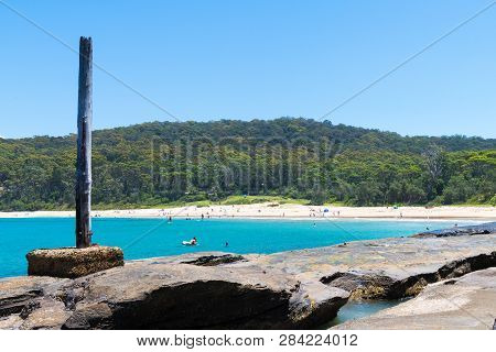 People Enjoying The Sunny Weather At Pebbly Beach, A Popular Camping Area With Great Surfing Beach A