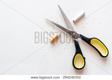 Stop Smoking Cigarettes Concept. Scissors And A Cut Cigarette On A White Background
