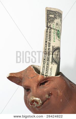 broken money box with one torn dollar