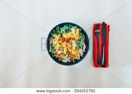 Salad made from radiatori cooked pasta, goat cheese and oil vinaigrette