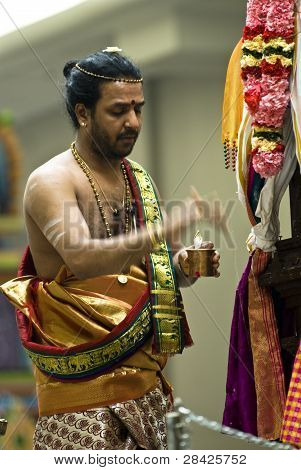 Hindu Priest Performs The Pooja For The Hindu Devotees During The Chariot Festival At Richmomd Hill