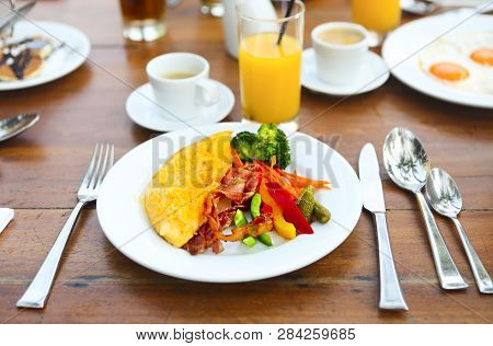 Omelet With Pepper, Cucumber, Bakon And Salad On The Table Outdoors