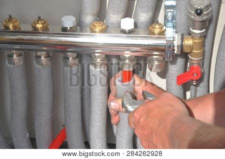 Radiant Floor Heating Installation. Repair Floor Heating System With Insulated Metal Pipes.