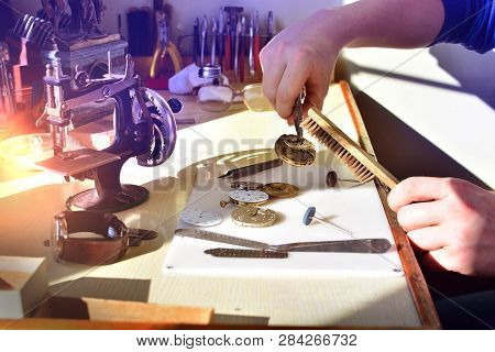 Watchmaker Repairs Watch In Workshop. Workplace Of Watch Repairer. Process Of Repair Mechanical Watc