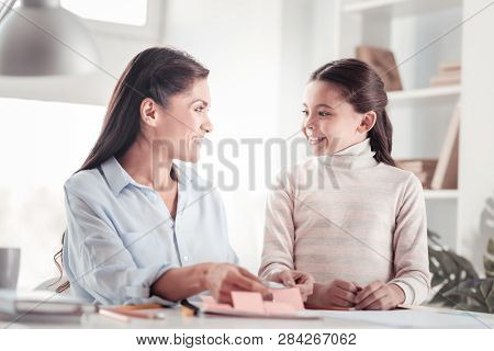 Well-behaved Glad Daughter Helping Mother With Work