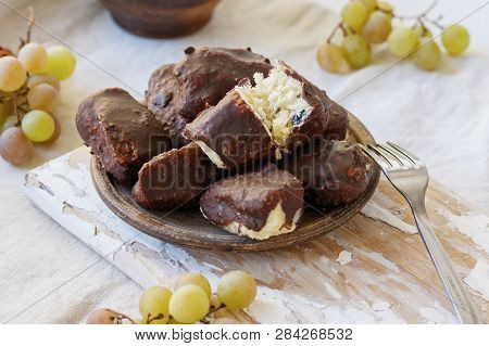 Alternative Cheeses Without Milk From Millet, Coconut Chips And Raisins, Covered With Homemade Choco