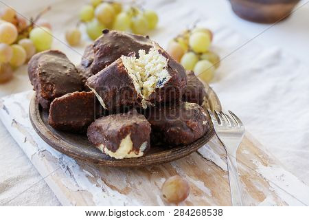 Alternative Cheeses Without Milk From Millet, Coconut Chips And Raisins, Covered With Homemade Choco