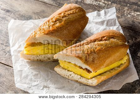 Bocadillo De Tortilla Española. Spanish Potato Omelette Sandwich On Wooden Table.