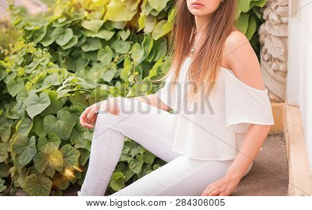Girl In White Sitting On The Steps