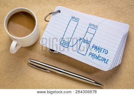 Pareto 80-20 principle concept - a sketch on a stack of index cards with a cup of coffee and  a pen