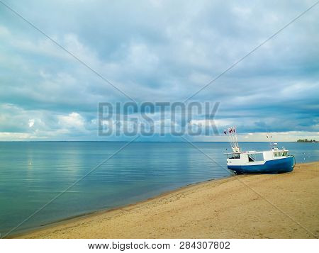 Fishing Boat On Baltic Sea Coast. Stormy Weather. Mechelinki, Poland, Pucka Bay.