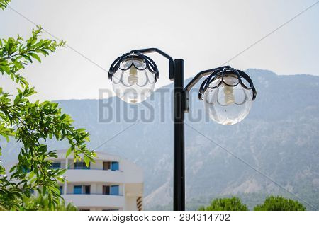 Energy-saving Light Bulbs In The Lantern On The Nature Near The Mountains