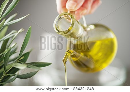 Bottle Of Virgin Olive Oil Pouring Close Up