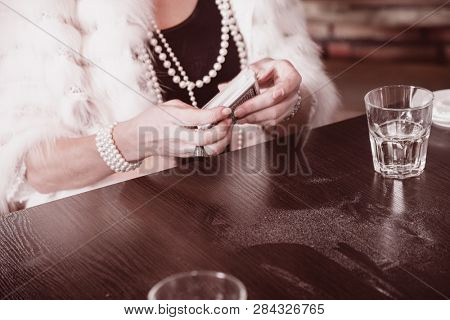 women's hands sharper prevents a deck of cards in an underground casino. close-up