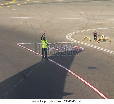 Land Crew At The Airport Makes Signs On The Runway