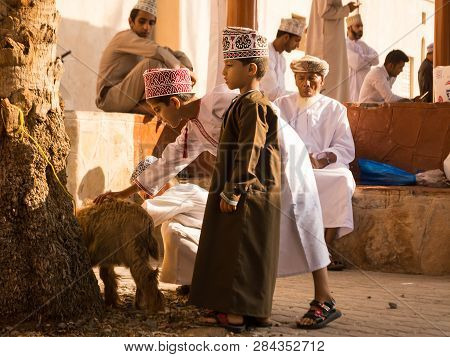 Nizwa, Oman - November 2, 2018: Omani Children Play With Animals At The Nizwa Friday Market