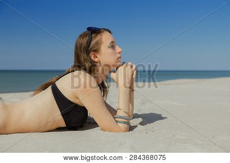 Beautiful Young Woman In Swimsuit At Sand Sea Beach Looking At Camera, Toned Image