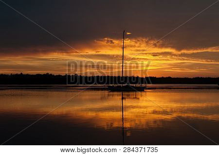 At Anchor On The River While Waiting For The Sun To Set