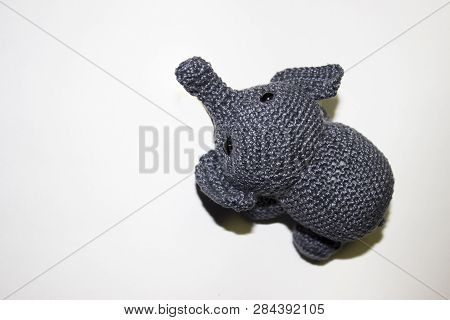 Little Grey Elephant Crocheted Sitting On White Background Top View