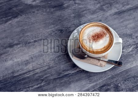 Capucinno Cream On Top Of Coffee Cup On Stone Table