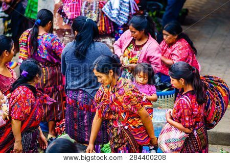 Chichicastenango, Guatemala On 2th May 2016: Group Of Indigenous Maya Woman With A Baby On Their Bac