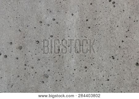 Gray Concrete Wall With Small Shallow Craters