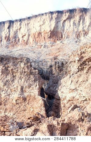 Rockslide. Mountain Landslide In An Environmentally Hazardous Area. Large Cracks In Earth, Descent O