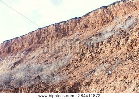 Rockslide. Mountain Landslide In An Environmentally Hazardous Area. Large Cracks In Earth, Descent O