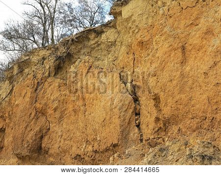 Rockslide. Mountain Landslide In An Environmentally Hazardous Area. Large Cracks In Earth, Descent O