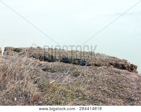 Rockslide. Mountain Landslide In An Environmentally Hazardous Area. Large Cracks In Earth, Descent O