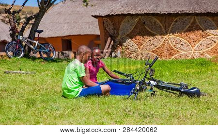 African Children Fixing A Puncture On A Bike