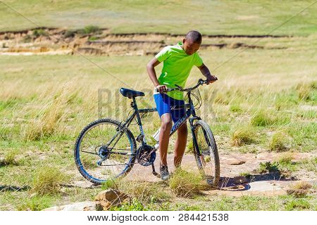 African Children Riding A Bike In Rural A Village