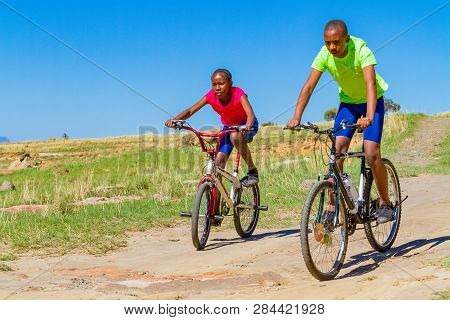African Children Riding A Bike In Rural A Village