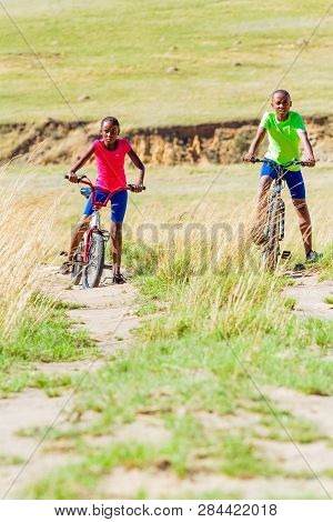 African Children Riding A Bike In Rural A Village